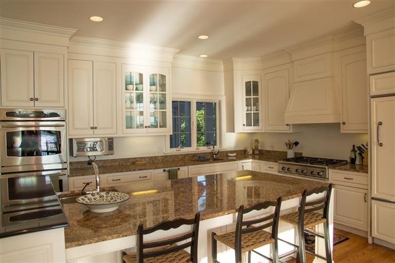 429 Monomoscoy Road Mashpee, MA 02649 - Photo 6 of 26 a kitchen with kitchen island granite countertop a sink and white cabinets