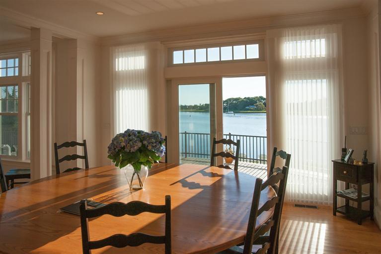 429 Monomoscoy Road Mashpee, MA 02649 - Photo 8 of 26 a view of a dining room with furniture window and wooden floor