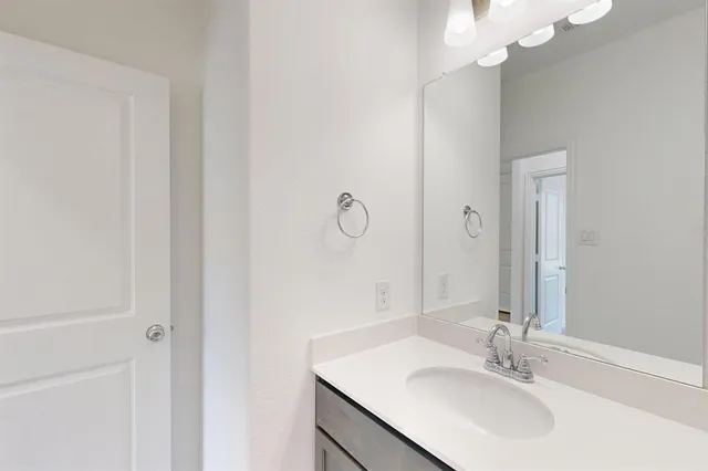 a bathroom with a sink vanity and a mirror
