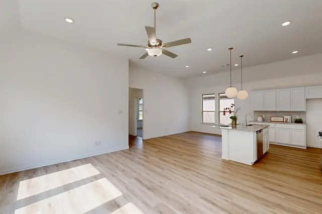 a view of a kitchen with a stove cabinets and wooden floor