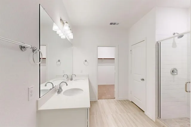 a bathroom with a sink a mirror and shower