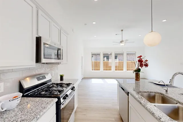 a kitchen that has a sink and a stove