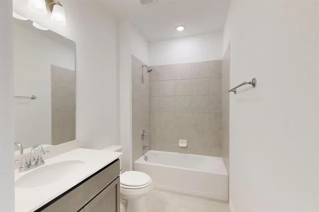 a bathroom with a sink a toilet and bathtub