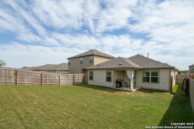 a view of a house with a backyard