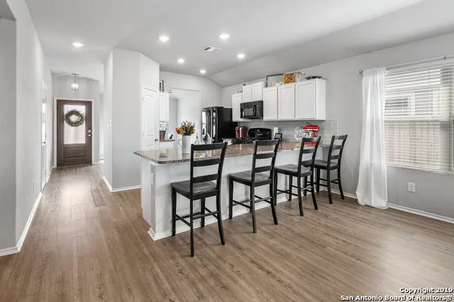 a view of a dining room with furniture and wooden floor