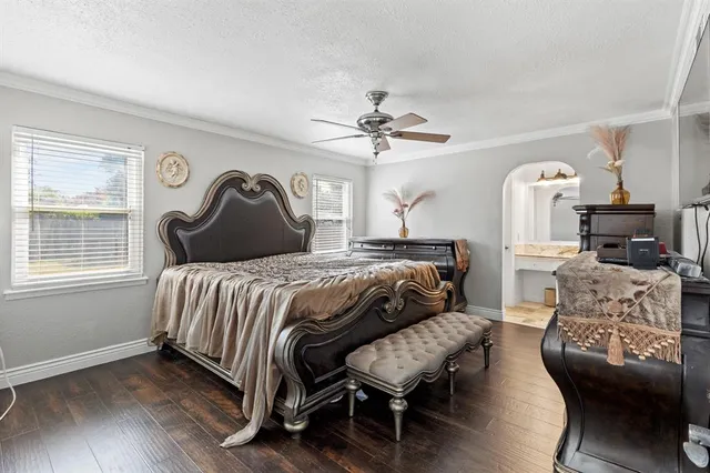 a bedroom with a bed mirror and a window