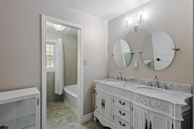 a bathroom with a granite countertop double vanity sink toilet and a mirror