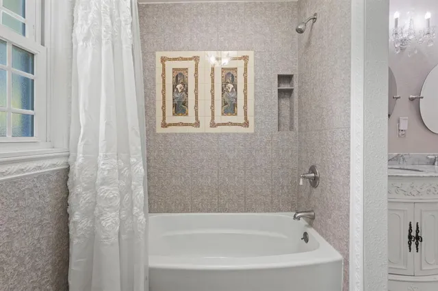 a white bath tub sitting next to a window