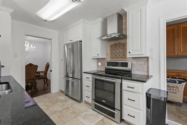 a kitchen with stainless steel appliances granite countertop a stove microwave and refrigerator