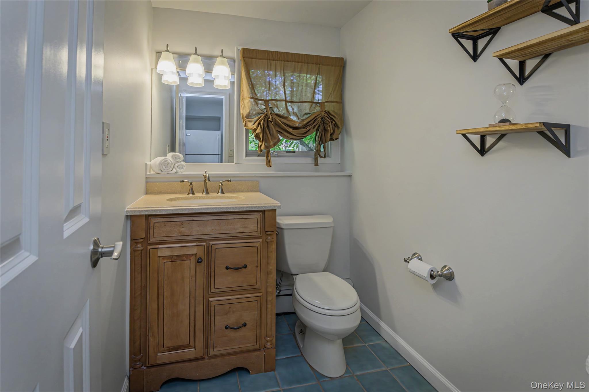 41 Cross Pond Road Pound Ridge, NY 10576 - Photo 13 of 41 a bathroom with a sink a toilet and mirror