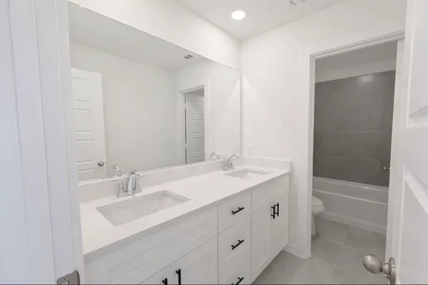 a spacious bathroom with a granite countertop sink