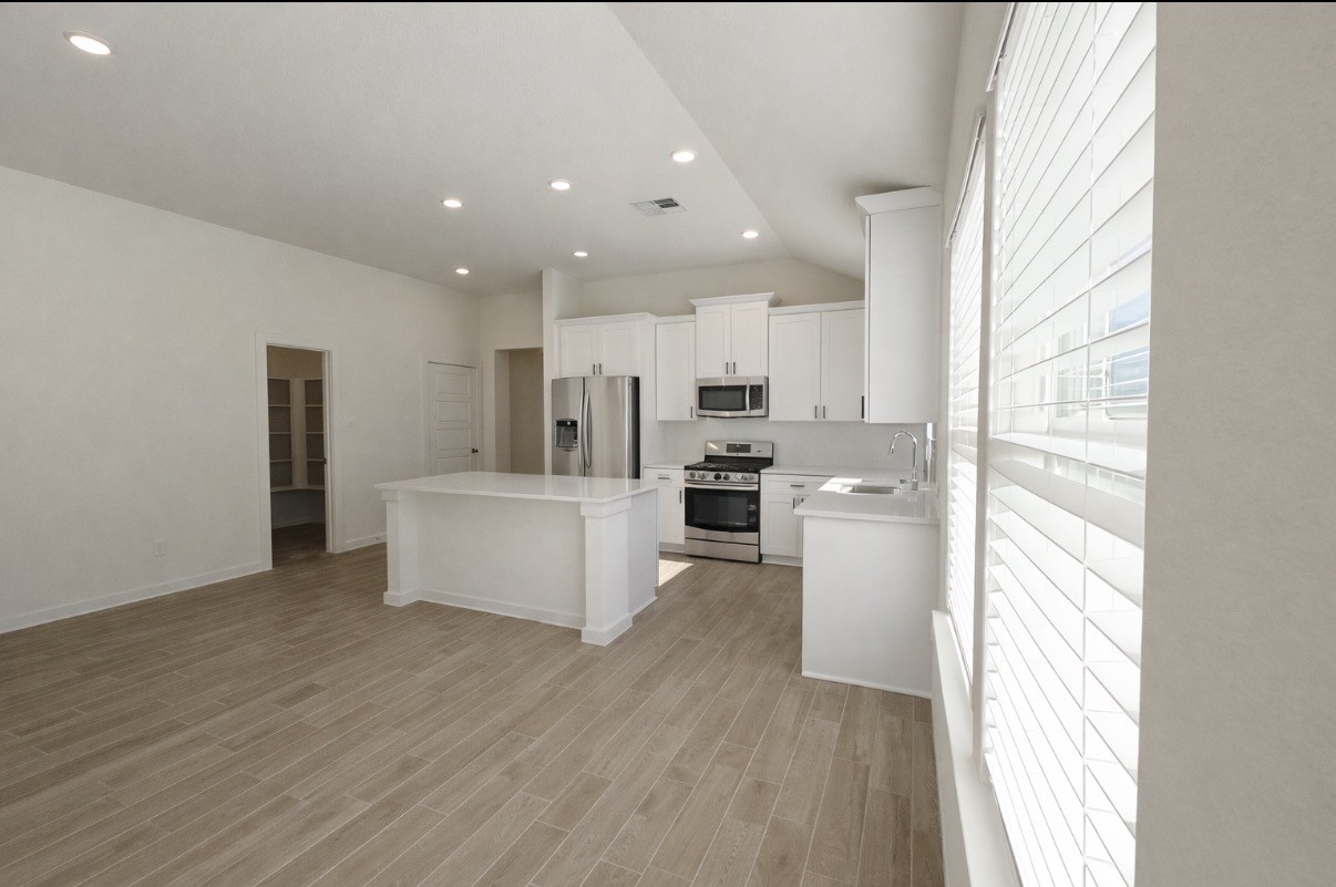 8315 Amber Summit Lane Angleton, TX 77515 - Photo 21 of 21 a kitchen with stainless steel appliances a refrigerator and a stove top oven
