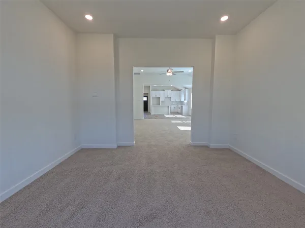 a view of a livingroom and a empty room