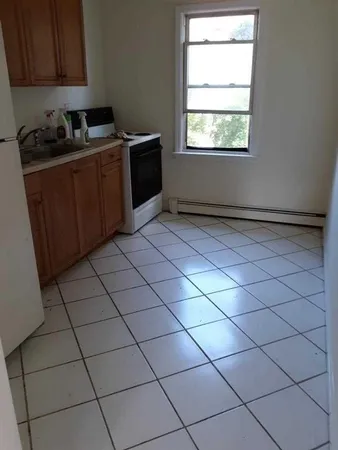a kitchen with stainless steel appliances a sink window and cabinets
