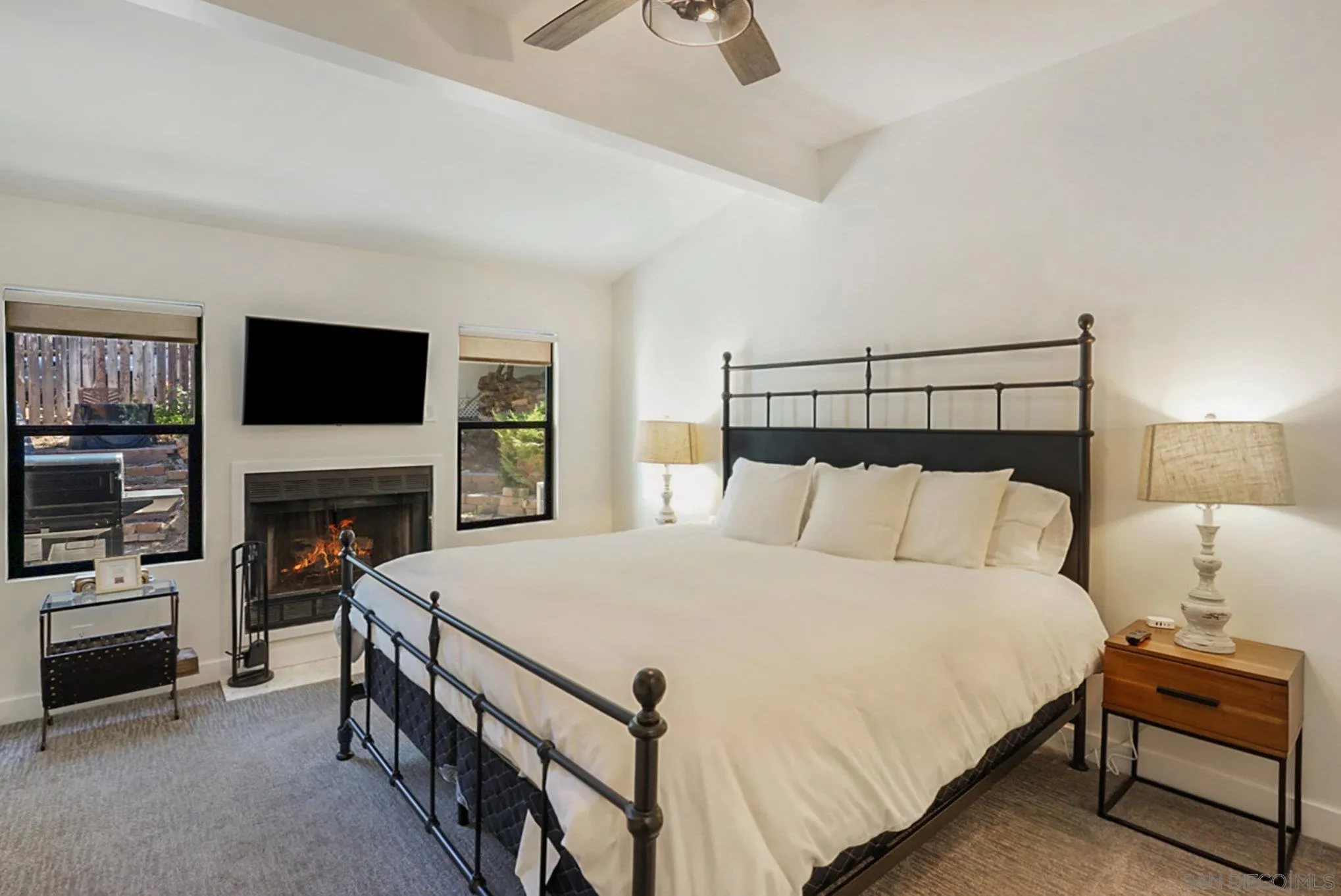 2020 3rd Street Julian, CA 92036 - Photo 11 of 34 a spacious bedroom with a bed and a flat screen tv