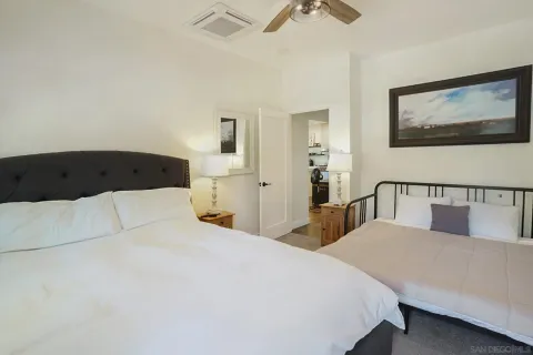 a bedroom with a large bed and a lamp