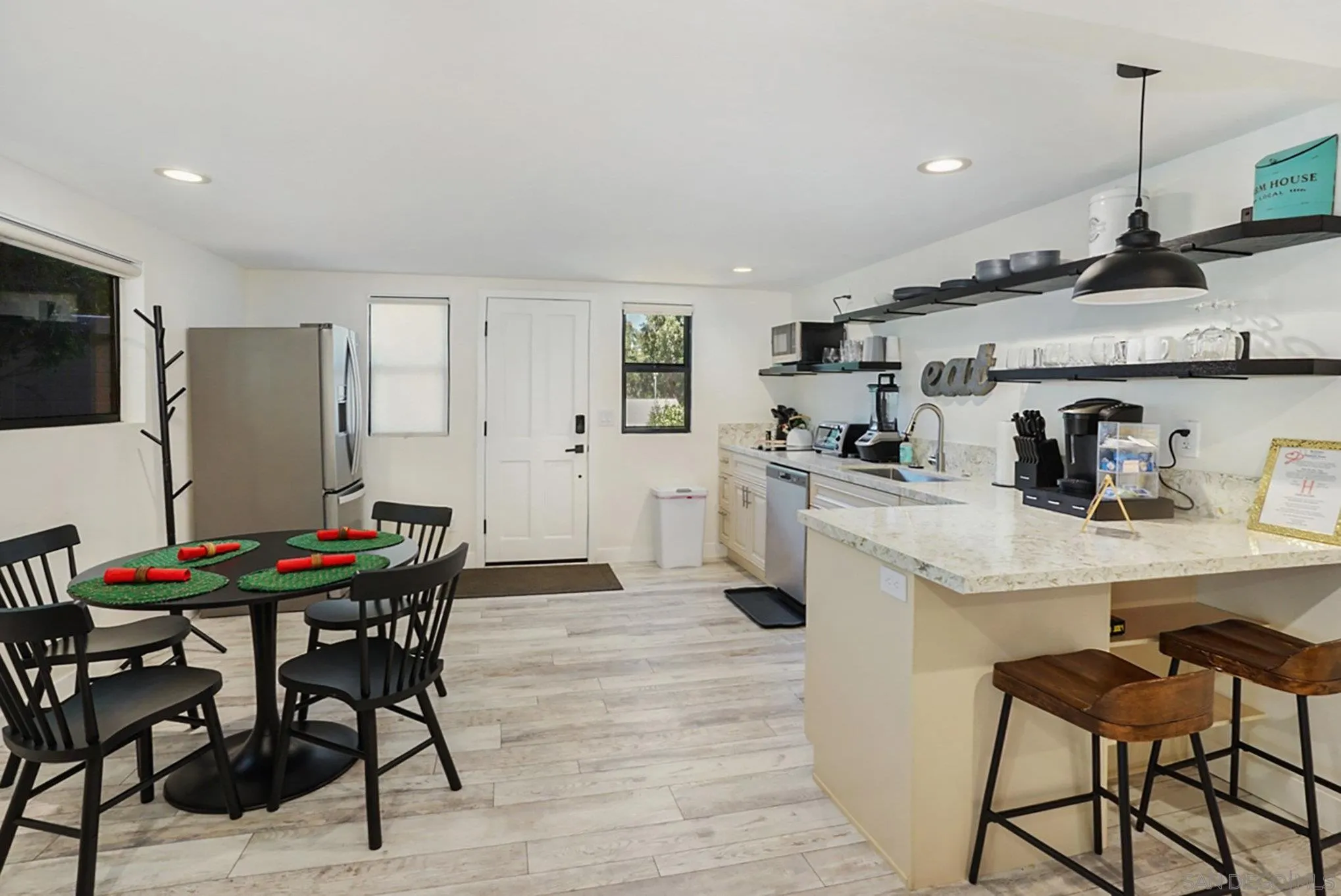 2020 3rd Street Julian, CA 92036 - Photo 15 of 34 a kitchen with stainless steel appliances granite countertop a sink a stove a refrigerator and a dining table with wooden floor