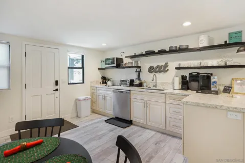 a kitchen with granite countertop a sink cabinets and window