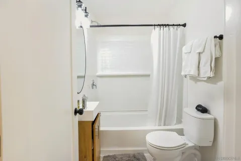 a bathroom with a toilet and a shower
