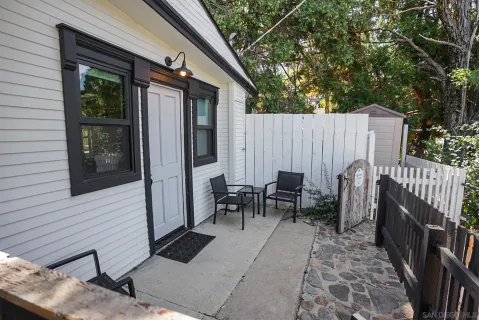 a view of a dinning table and chairs in patio of the house