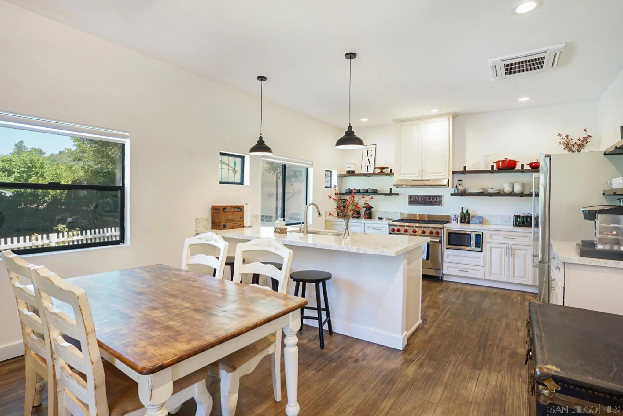 2020 3rd Street Julian, CA 92036 - Photo 7 of 34 a kitchen with a table chairs and white cabinets