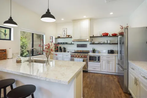 a kitchen with stainless steel appliances granite countertop a sink counter space and cabinets