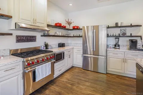 a kitchen with stainless steel appliances granite countertop a stove and a refrigerator
