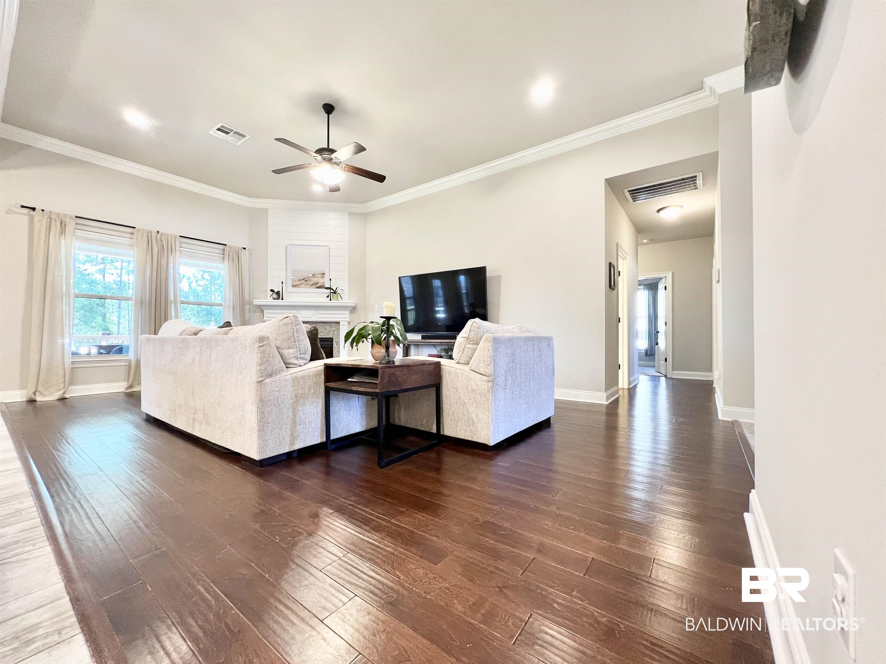 32290 Calder Court Daphne, AL 36527 - Photo 11 of 59 Living room with dark wood-type flooring, crown molding, and ceiling fan