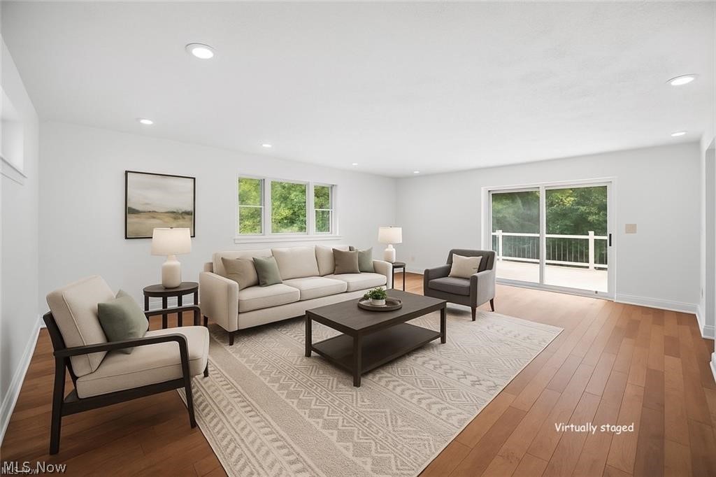 28300 Aurora Road Solon, OH 44139 - Photo 11 of 36 Spacious living area featuring polished wood-finish flooring, white walls, and recessed lighting