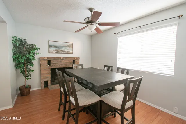 a view of a dining room with furniture and a potted plant
