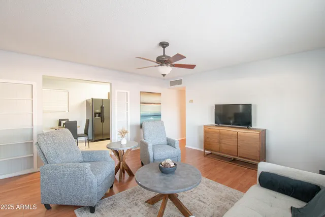 a living room with furniture a rug and a flat screen tv