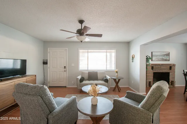 a living room with furniture a fireplace and a flat screen tv