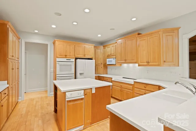 a kitchen with a sink a stove and cabinets