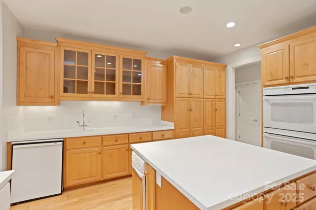 a kitchen with a refrigerator sink and cabinets