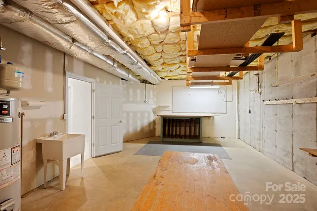 a view of an empty room with a fireplace and a window
