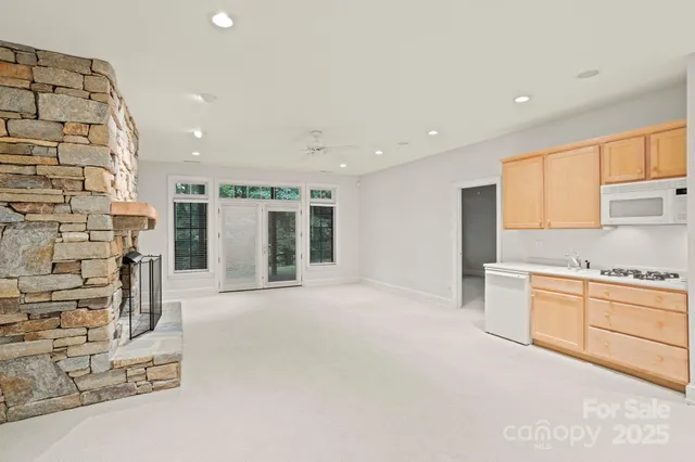 a kitchen with granite countertop cabinets stainless steel appliances and a sink