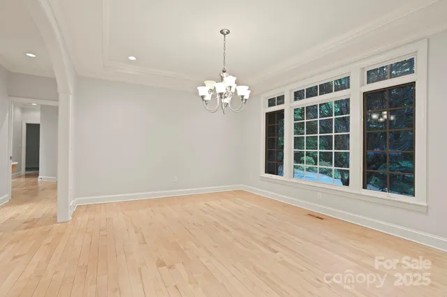 a view of a room with windows and chandelier