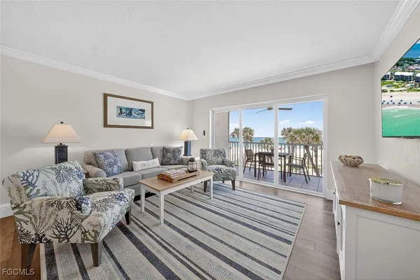 a living room with furniture and a dining table