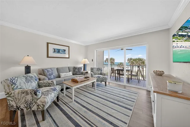 a living room with furniture and a dining table