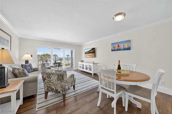 a dining room with furniture and wooden floor