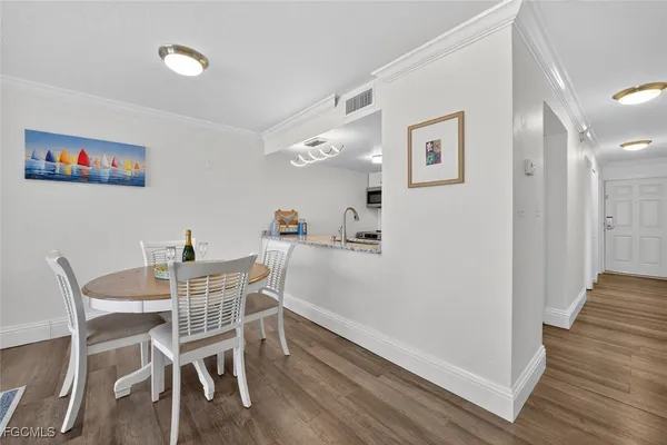 a kitchen with dining table and chairs