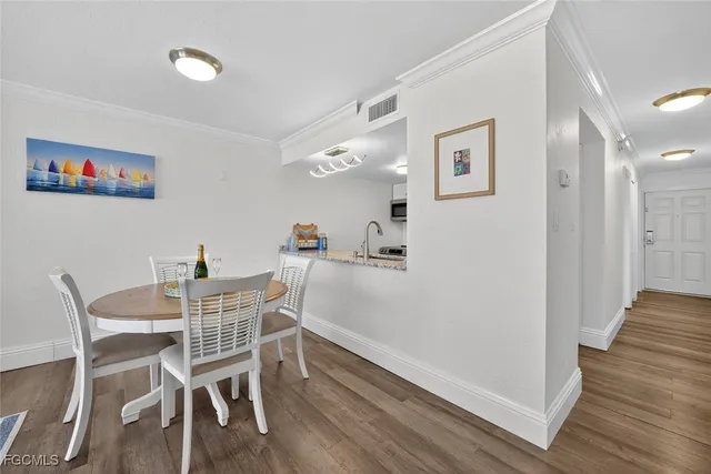 a kitchen with dining table and chairs