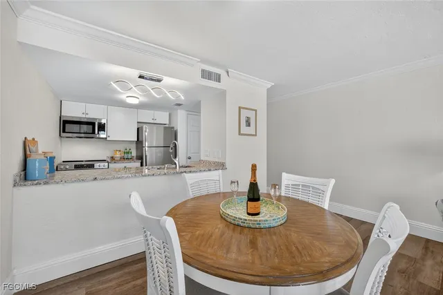 a kitchen with cabinets and wooden floor