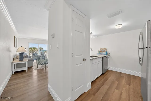 a kitchen with a sink a counter space and cabinets