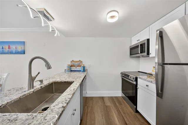 a view of hallway with wooden floor