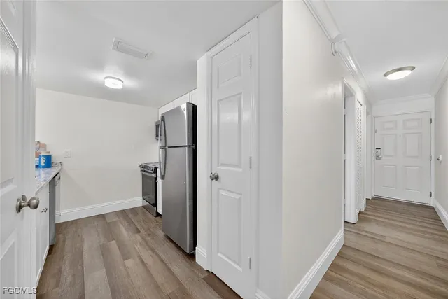 a bedroom with a large bed and a wooden floor