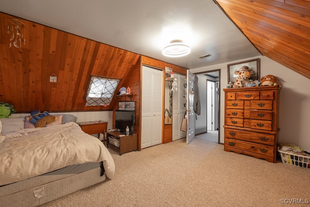 6006 Indigo Road Richmond, VA 23230 - Photo 32 of 48 Carpeted bedroom featuring wooden walls and two cl