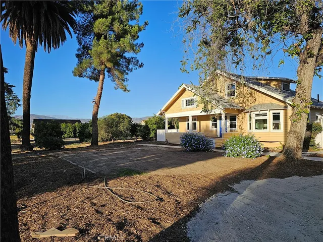 a front view of a house with a garden and yard