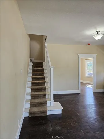 a view of entryway and hall with wooden floor