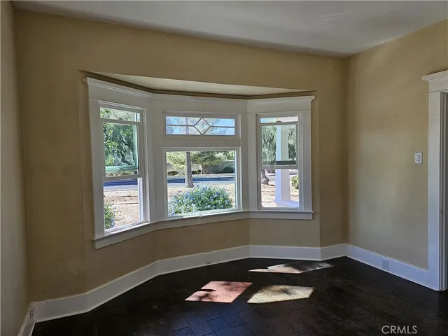 a room with wooden floor and a window